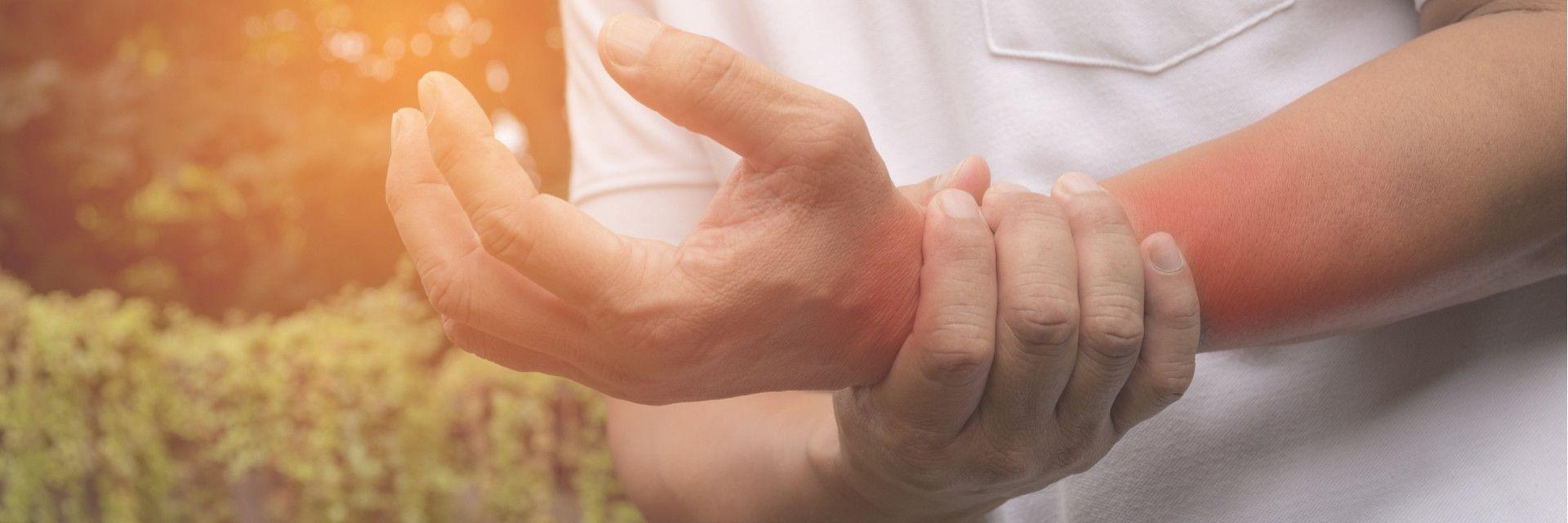 Man holding wrist in pain