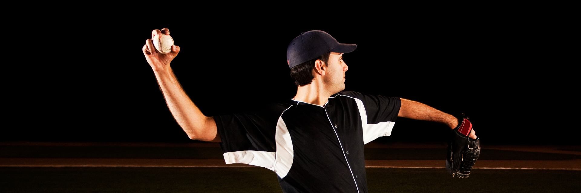 Baseball pitcher in mid-pitch